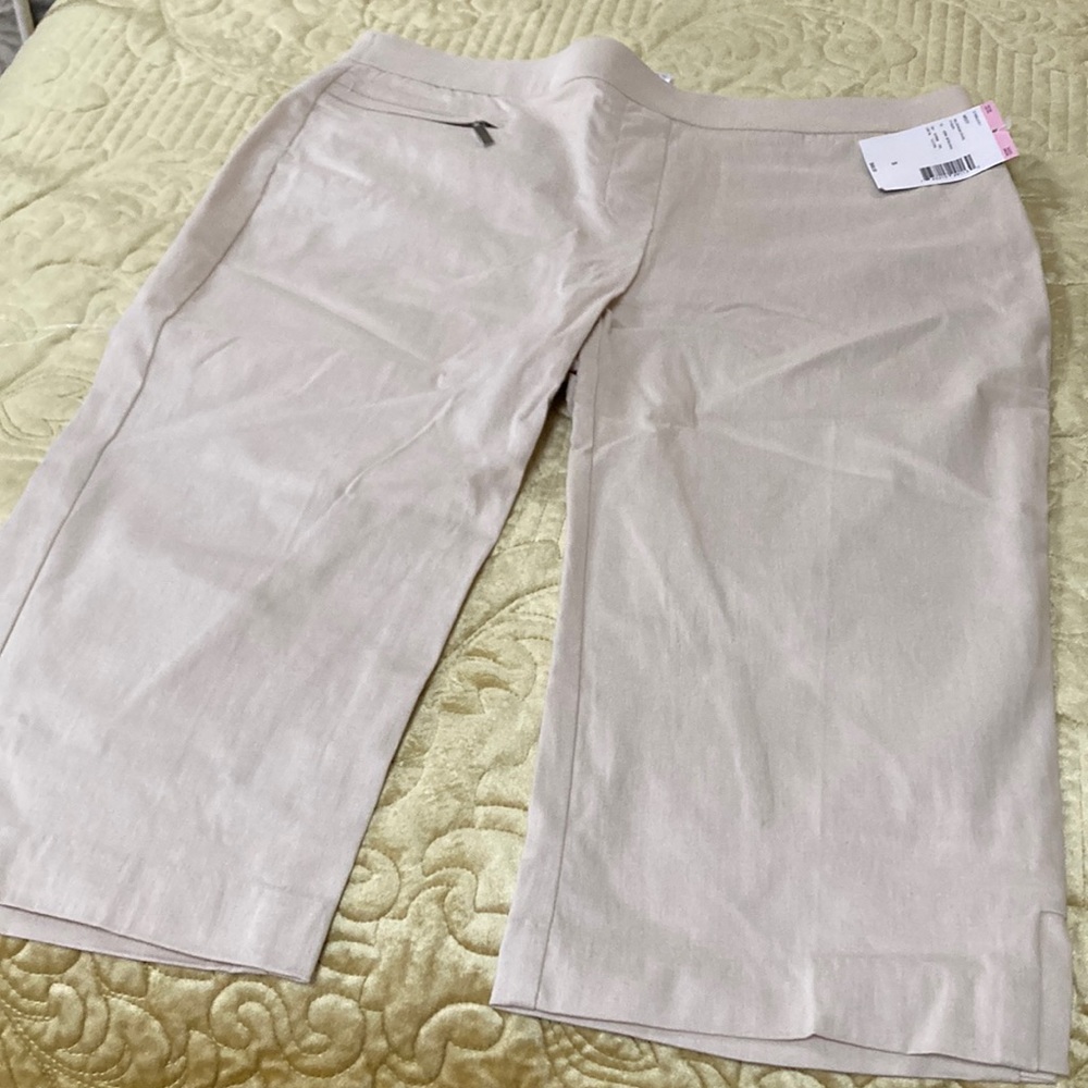 Beige stretchy pull on capris with a nice zippered pocket in the front